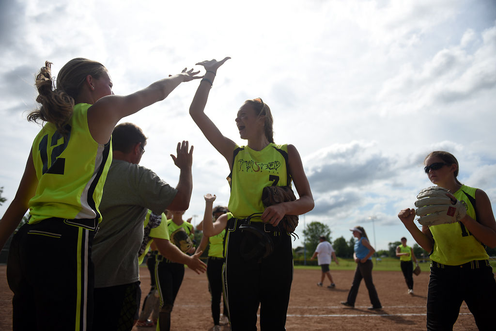 Olivia Wood, 15, center, celebrates with her teammates